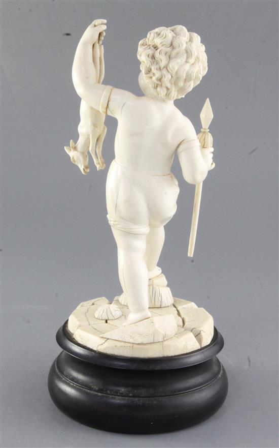 A 19th century Dieppe carved ivory figure of a putto holding a dead deer, height 12in.